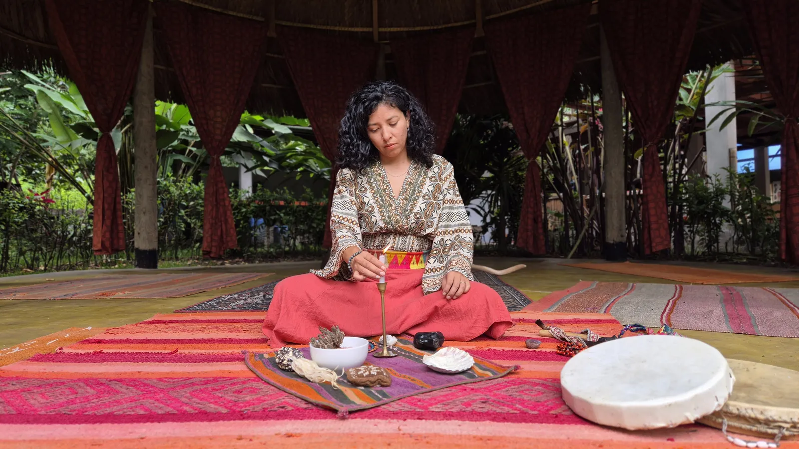 Mar in meditation with mesa and drum in the maloca — the stillness before energy work begins