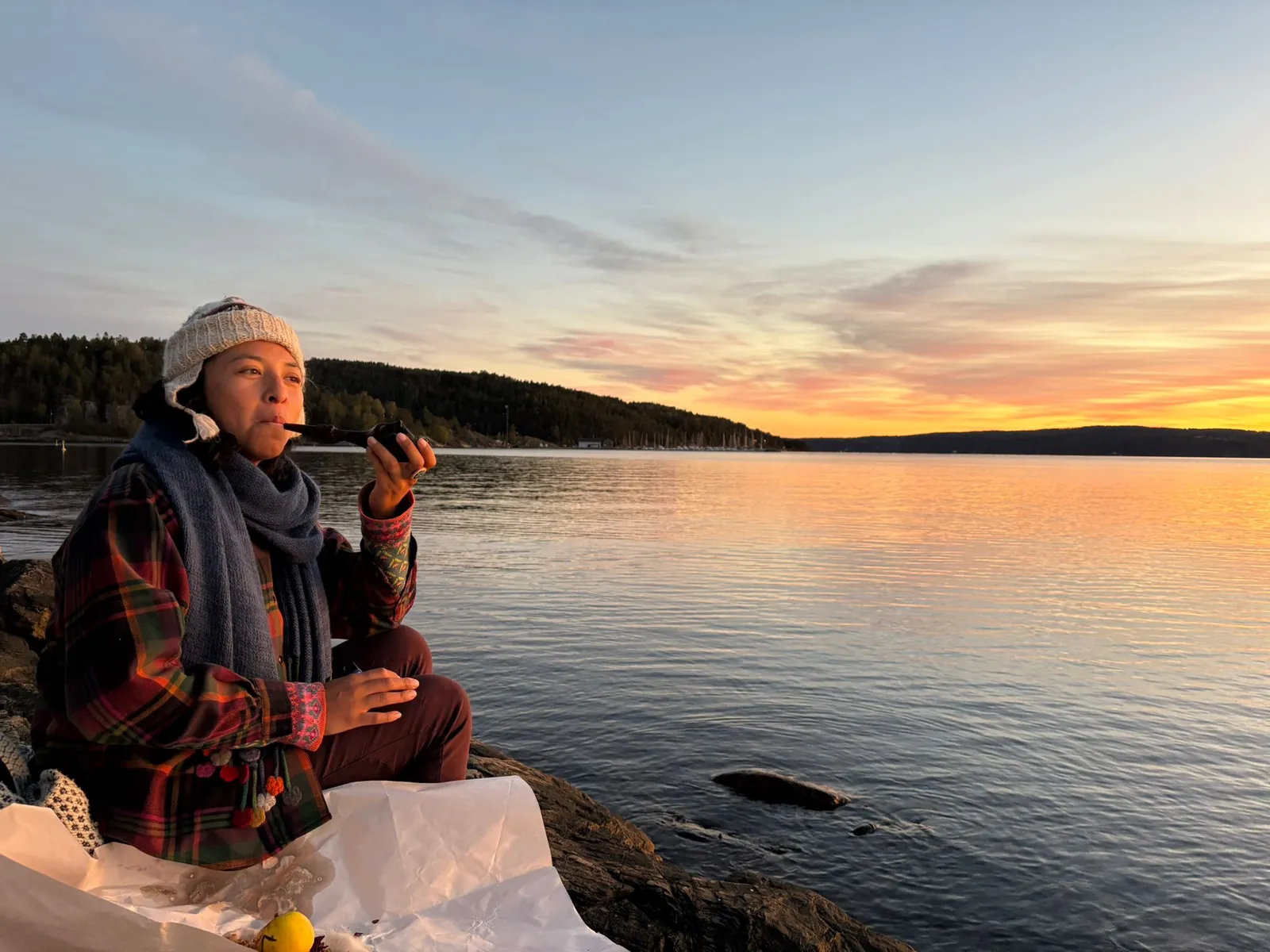 Mar with tobacco medicine by the Norwegian fjord at sunset